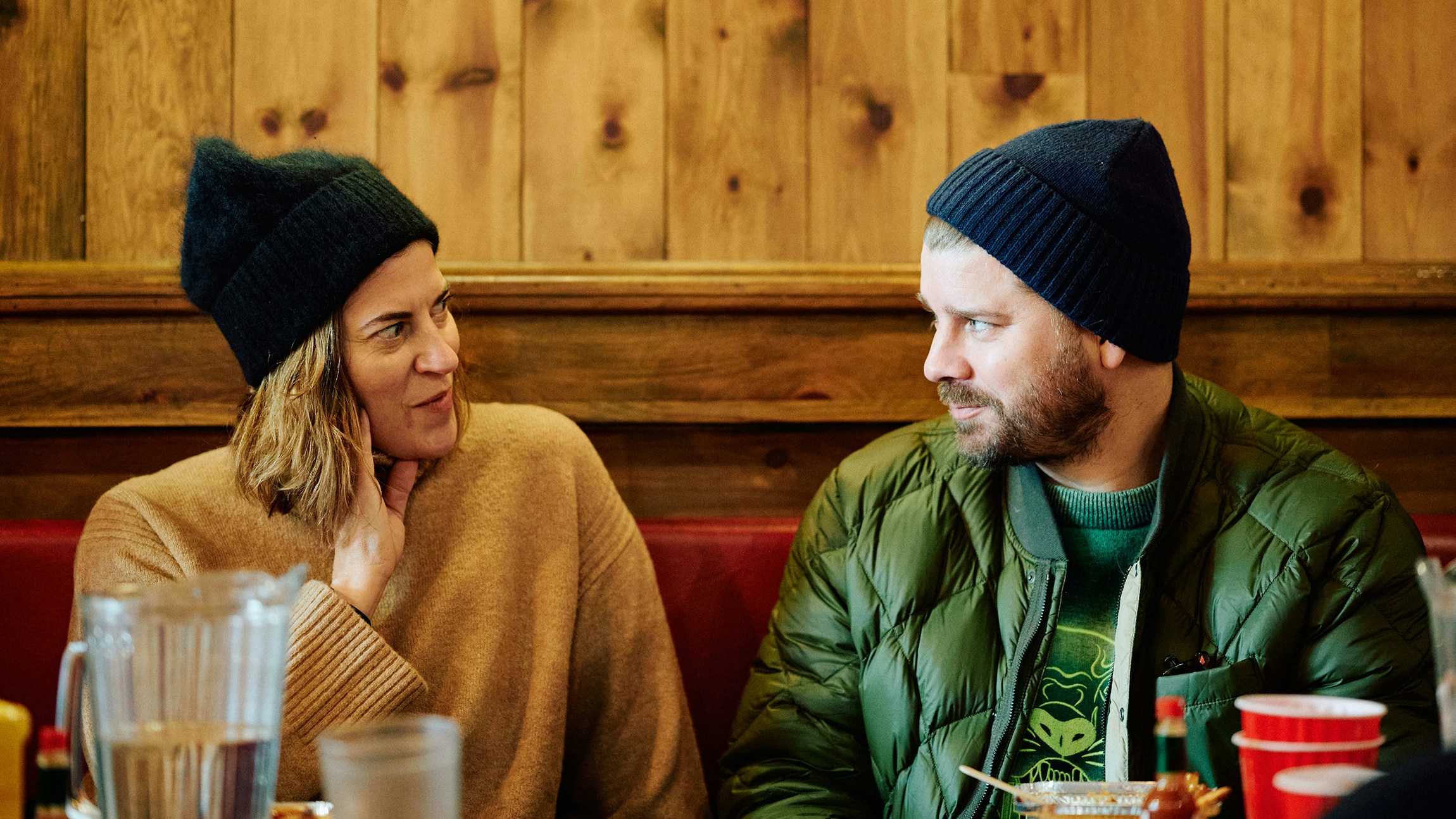 Two teammates chatting over brunch at a Montreal café during offsite
