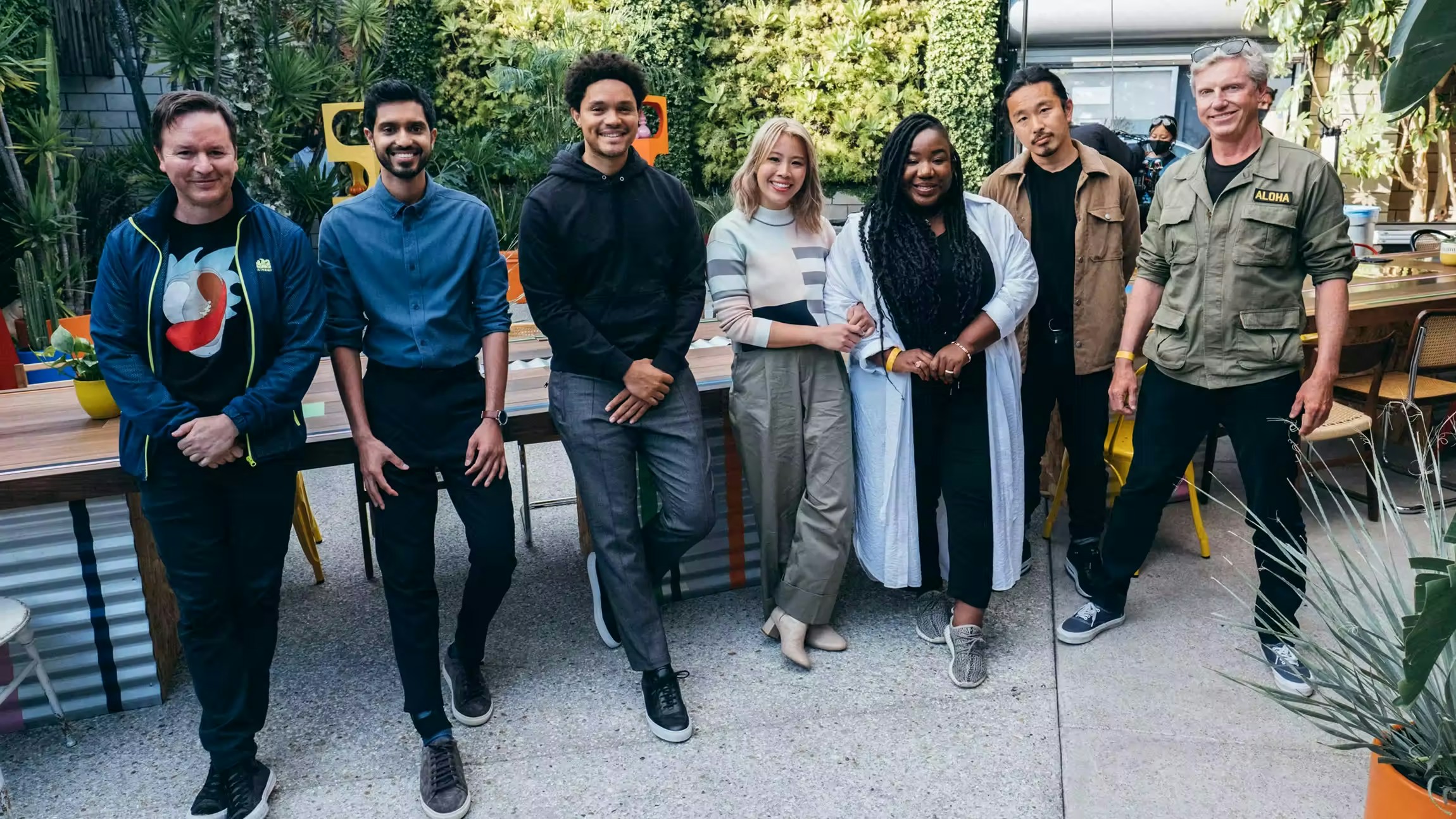 Trevor Noah and Alto team standing in front of an Expensify sign