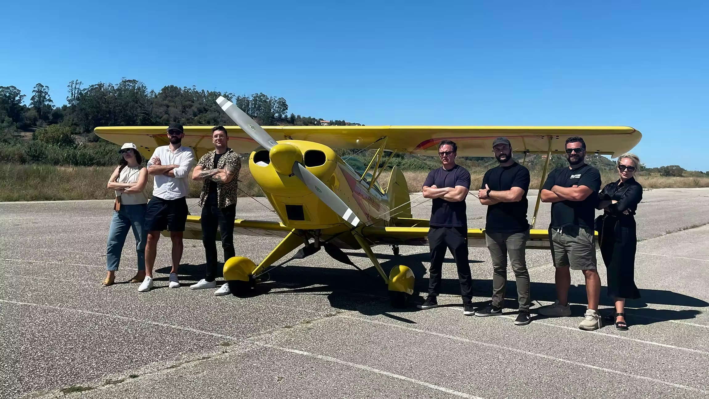 Behind-the-scenes view of the Alto team on set, working near a private plane for an Upwork client project